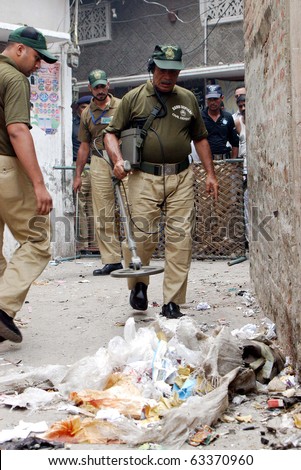 LAHORE, PAKISTAN - OCT 18: Bomb disposal squad officials examine the site of cracker blast on October 18, 2010 in Lahore.