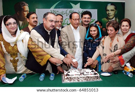 ISLAMABAD, PAKISTAN - NOV 09: Muslim League-Q President, Ch.Shujaat Hussain, cuts cake during ceremony on occasion of the ?Iqbal Day? held at PML-Q Secretariat on November 09, 2010 in Islamabad.