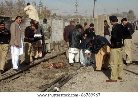 QUETTA, PAKISTAN - DEC 07: Police officials collect evidences at the site following attack on convoy of the Balochistan Chief Minister on December 07, 2010 in Quetta, Pakistan.