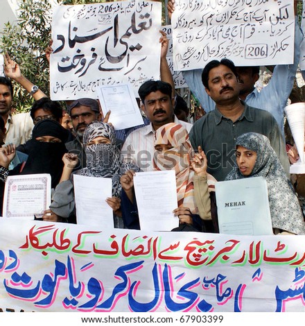 HYDERABAD, PAKISTAN - DEC 27: Members of Junior Teachers Action Forum chant slogans for restoration of two-hundred and six junior teachers during protest on December 27, 2010 in Hyderabad.