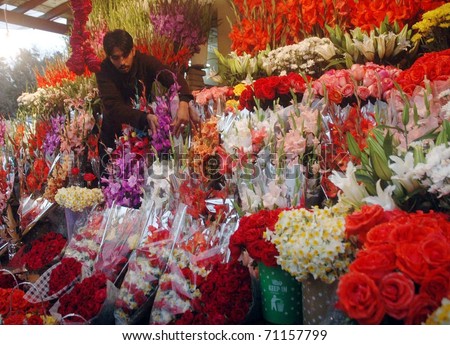ISLAMABAD, PAKISTAN - FEB 13: Youth arranges floral bouquets to attract customers at his stall on the Eve of Valentine\'s Day festival on February 13, 2011in Islamabad.