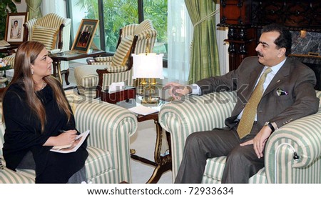ISLAMABAD, PAKISTAN - MAR 10: Prime Minister Syed Yousuf Raza Gilani, talks with Astronaut, Namira Saleem, during meeting at PM House on March 10, 2011.in Islamabad, Pakistan.