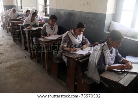 KARACHI, PAKISTAN - APR 18: Students of ninth class solve papers at an examination centre during Annual Examination 2011 on April 18, 2011 in Karachi.