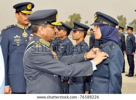 RISALPUR, PAKISTAN - APR 28: Air Chief Marshal Rao Qamar Suleman, Chief of the Air Staff, awards Flying Badges and Branch Insignias to graduating officers at PAF Academy on April 28, 2011 in Risalpur, Pakistan.