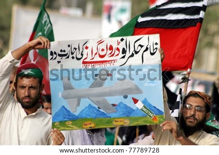 KARACHI, PAKISTAN - MAY 22: Supporters of Tehreek-e-Insaf (PTI) hold a poster on the second day of sit-in against US drone attacks at Netty Jetty Bridge on May 22, 2011 in Karachi.