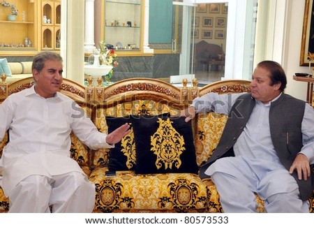 LAHORE, PAKISTAN - JUL 6: Muslim League-N Chief, Nawaz Sharif exchanges views with Shah Mehmood Qureshi former Federal Minister for Foreign Affairs, during meeting on July 06, 2011 in Lahore.