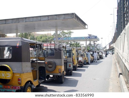 KARACHI, PAKISTAN - AUG 23: View of a long queue of motorists at an opened CNG station at a road during day of mourning and condemnation called by MQM on August 23, 2011in Karachi.