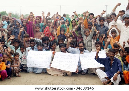 HYDERABAD, PAKISTAN - SEPT. 14: Rain affected people from Badin chant slogans in favor of their demands during protest demonstration at Hala Naka area in Hyderabad, Pakistan on  September 14, 2011.
