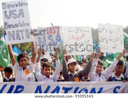 KARACHI, PAKISTAN - DEC 19: unidentified Supporters of Jamat-e-Islami (JI) chant slogans against US Government during Tahafuz-e-Pakistan rally at M.A.Jinnah road on December 19, 2011in Karachi.