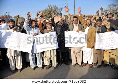 PESHAWAR, PAKISTAN - DEC 22: Members of WAPDA Hydro Electric Central Labor Union shout slogans in favor of their demands during a protest demonstration at Peshawar press club on December 22, 2011.