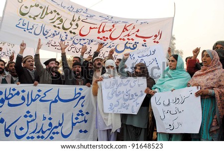 PESHAWAR, PAKISTAN, DEC 28: Members of National Labor Federation (NLF) chant slogans in favor of their demands during protest demonstration in Peshawar on Wednesday, December 28, 2011.