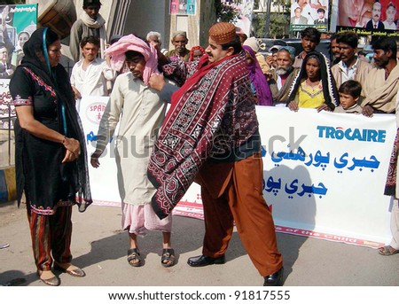 HYDERABAD, PAKISTAN, JAN 02: Activists present street theater on bonded laboring during rally arranged by Society for the Protection of the Rights of Child (SPARC) in Hyderabad, January 02, 2012.