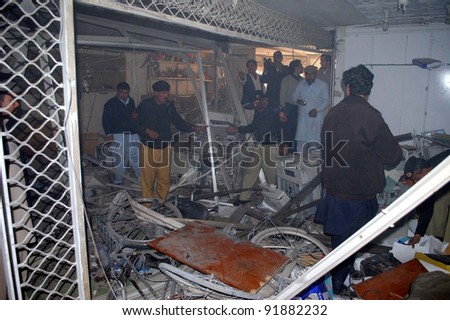 PESHAWAR, PAKISTAN, JAN 03: Security officials inspect the site of explosion after a planted bomb explosion in Peshawar on Tuesday, January 03, 2012.