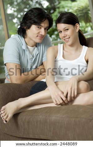 A young couple sitting together in their apartment