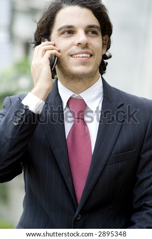 A young businessman using mobile phone outside (shallow depth of field used)