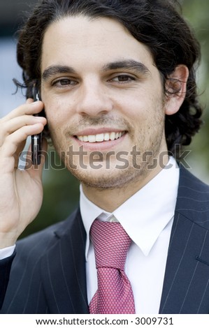 A young businessman outside using mobile phone (shallow depth of field used)