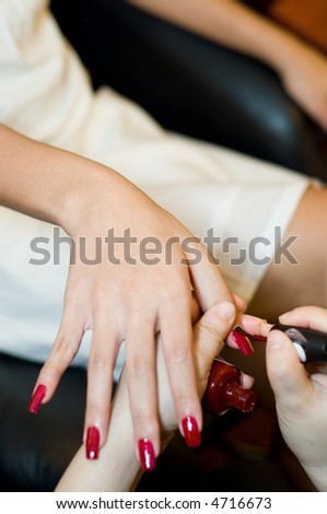 A young woman having her nails done in a spa