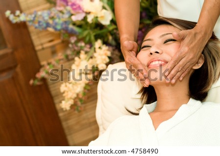 A young Asian woman having a face massage in a beauty salon