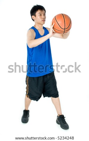 A teenage boy in blue sports vest and shorts with a basketball on white background