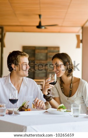 A young couple sitting together in a restaurant