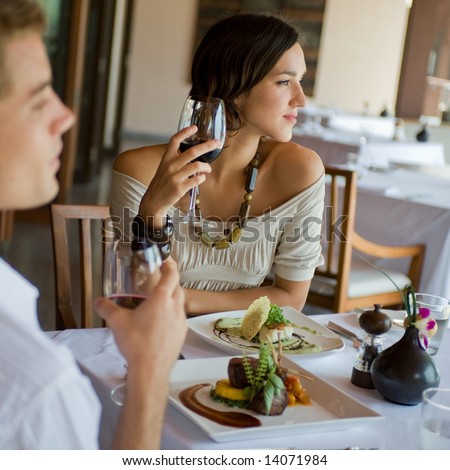 http://image.shutterstock.com/display_pic_with_logo/64665/64665,1214142051,1/stock-photo-a-young-couple-having-dinner-at-a-restaurant-14071984.jpg