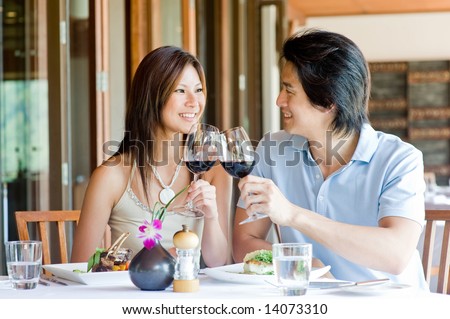 A young Asian couple having dinner at a restaurant