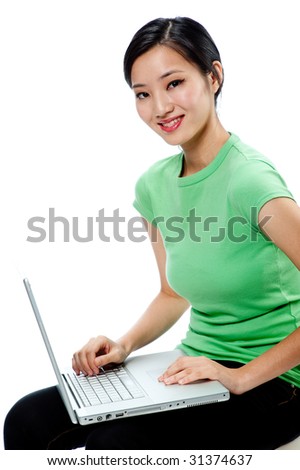An attractive Asian woman in a green shirt with laptop on white background