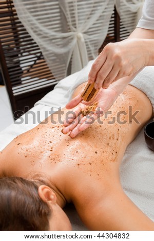 An attractive caucasian woman getting a scrub in a spa