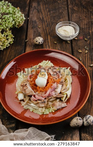 Meet salad in dark plate on wooden table
