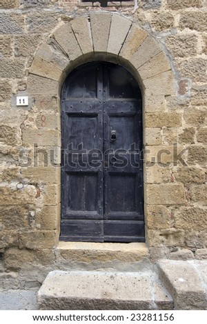 Old wooden door. Number 11. Italian style. Tuscany