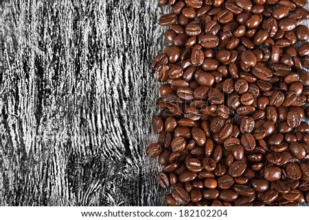 the fried beans of coffee on a wood background