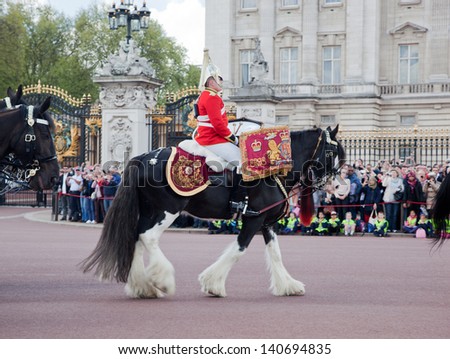 LONDON - MAY 17: British Royal guards riding on horse and perform the Changing of the Guard in Buckingham Palace on May 17, 2013 in London, UK