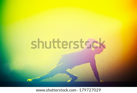 Hip hop, break dance performed by young man in colorful club lights. Breakdance party time