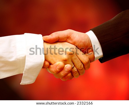 Business handshake on red background