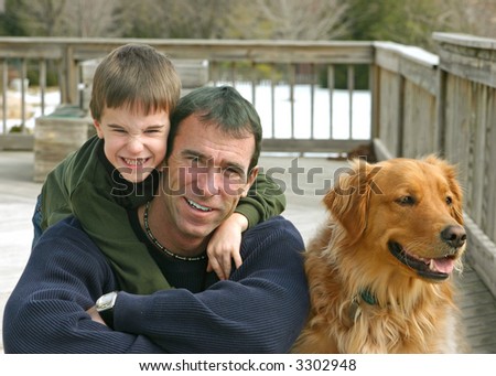 Father and son outside with the family dog