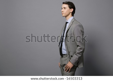 Attractive young businessman in gray suit.