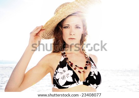 Portrait of young beautiful woman in black bikini. Shoot against sun.