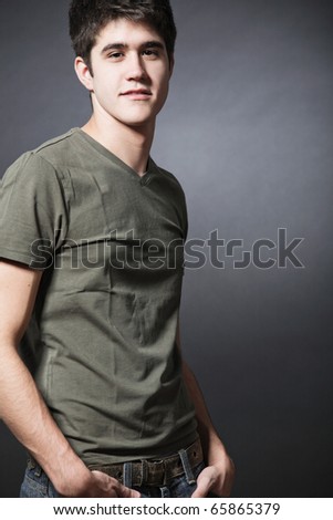 Young attractive happy man wearing green T-shirt.