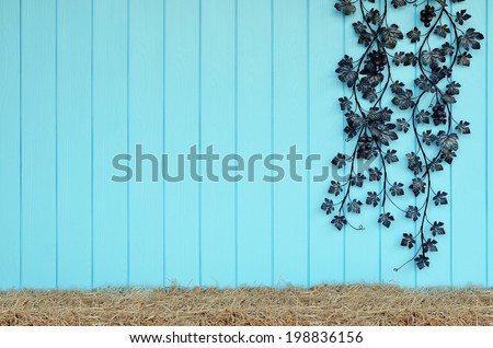 Artificial flowers and rice straw on blue wooden wall, Vintage style