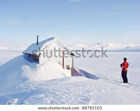 Boy at ski resting at a hunting lodge in the norwegian mountains at winter time