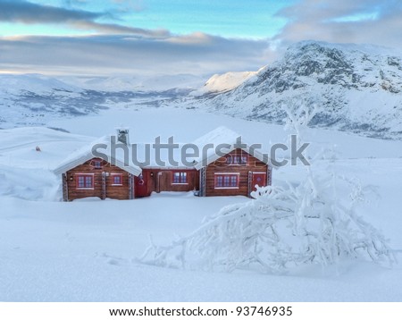 Cottage in the norwegian mountains with panoramic view during twilight hours at the coldest winter time