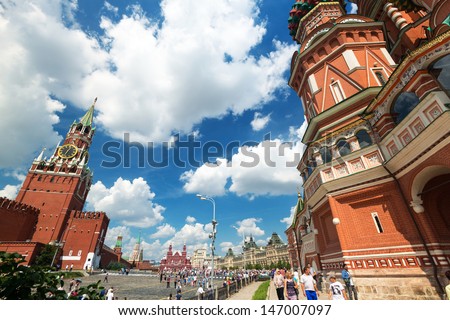 MOSCOW - JULY 13: Tourists visiting the Red Square on july 13, 2013 in Moscow, Russia. St. Basil\'s Cathedral and the Kremlin are the main attractions of the Red Square.