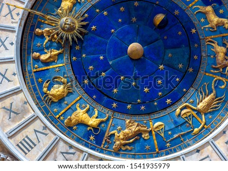 Astrological signs on ancient clock Torre dell'Orologio, Venice, Italy. Medieval Zodiac wheel and constellations. Golden symbols on star circle. Concept of astrology, horoscope and time.