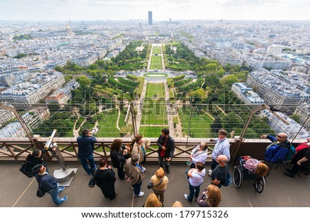 PARIS - SEPTEMBER 20, 2013: Tourists are on the observation deck of the Eiffel Tower. The Eiffel tower is one of the major tourist attractions of France.