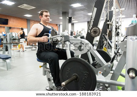 MOSCOW - SEP 17: Man engaged in physical exercise in the gym on september 17, 2013 in Moscow. Young people in Russia are increasingly visiting gyms.