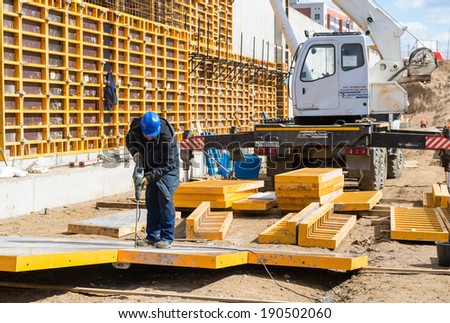 MOSCOW - APRIL 24: Construction site worker on april 24, 2014 in Moscow, Russia. Urban construction is at a faster pace in Russia.