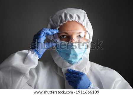 Similar – Image, Stock Photo Female doctor in coveralls holding COVID-19 PCR nasal swabbing kit