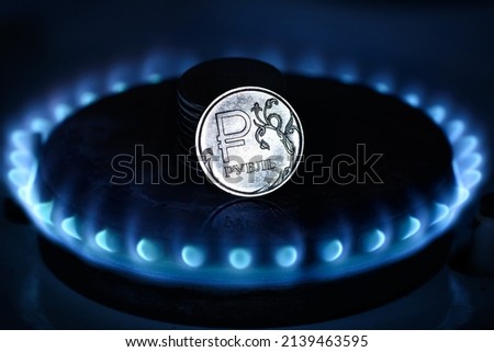 Gas burner and ruble coin, Russian money on home gas stove. Blue propane gas flame and ruble currency. Concept of Russia and Europe economy, natural gas cost, inflation, sanctions and payment.  商業照片 © 