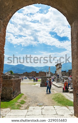 POMPEII, ITALY - MAY 13, 2014: Tourists visit the ruins of the city. Pompeii is an ancient Roman city died from the eruption of Mount Vesuvius in 79 AD.