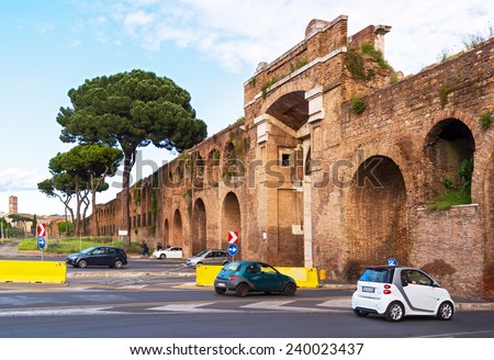 ROME, ITALY - MAY 14, 2014: Cars passing through the ancient wall of the Lateran Palace. Lateran Palace is one of the tourist attractions of Rome.